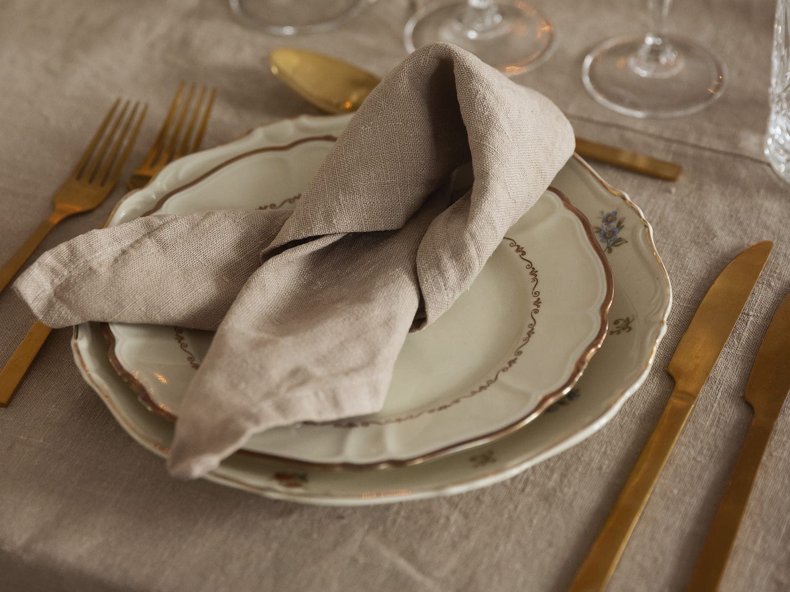 A linen napkin folded on a set table